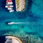 a boat entering a greek island harbor