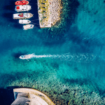 a boat entering a greek island harbor