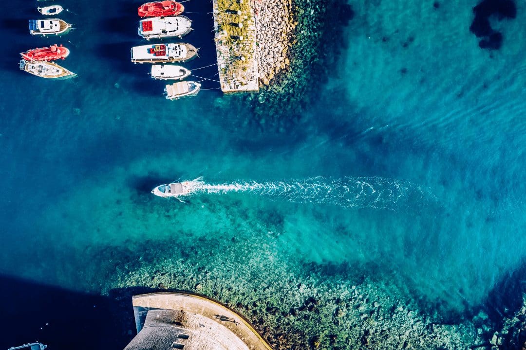 a boat entering a greek island harbor